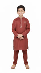 "Little boy wearing rust red embroidered kurta pajama set front view