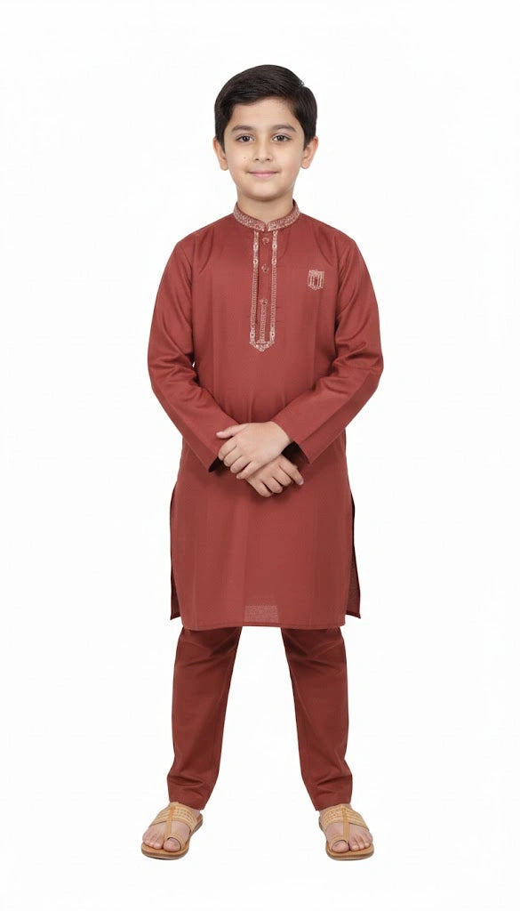 "Little boy wearing rust red embroidered kurta pajama set front view