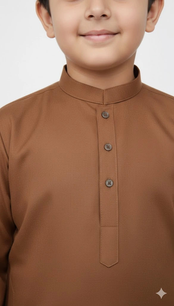 Little boy wearing Rust Brown Kurta Shalwar standing pose